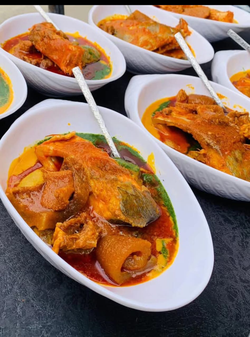 Bowls of native soup with assorted fish and meat ready for service