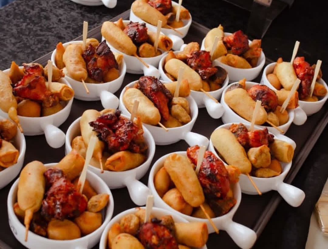 Small chops bowls with puff puff, spring rolls and grilled chicken skewers